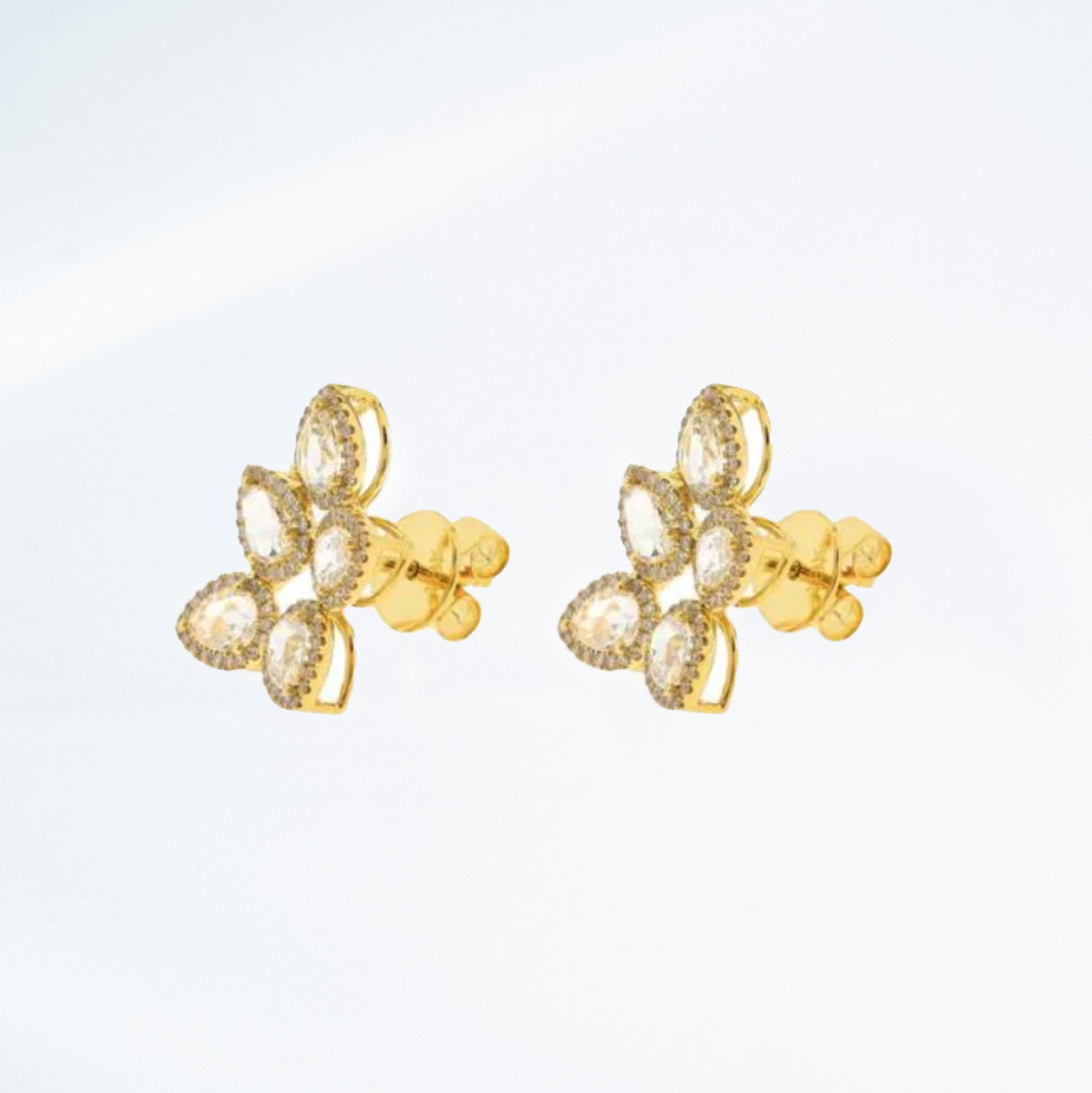 Side view 18k yellow gold and rose cut diamond earrings in the shape of a leaf. 5 points make up these earrings with pave diamond details.