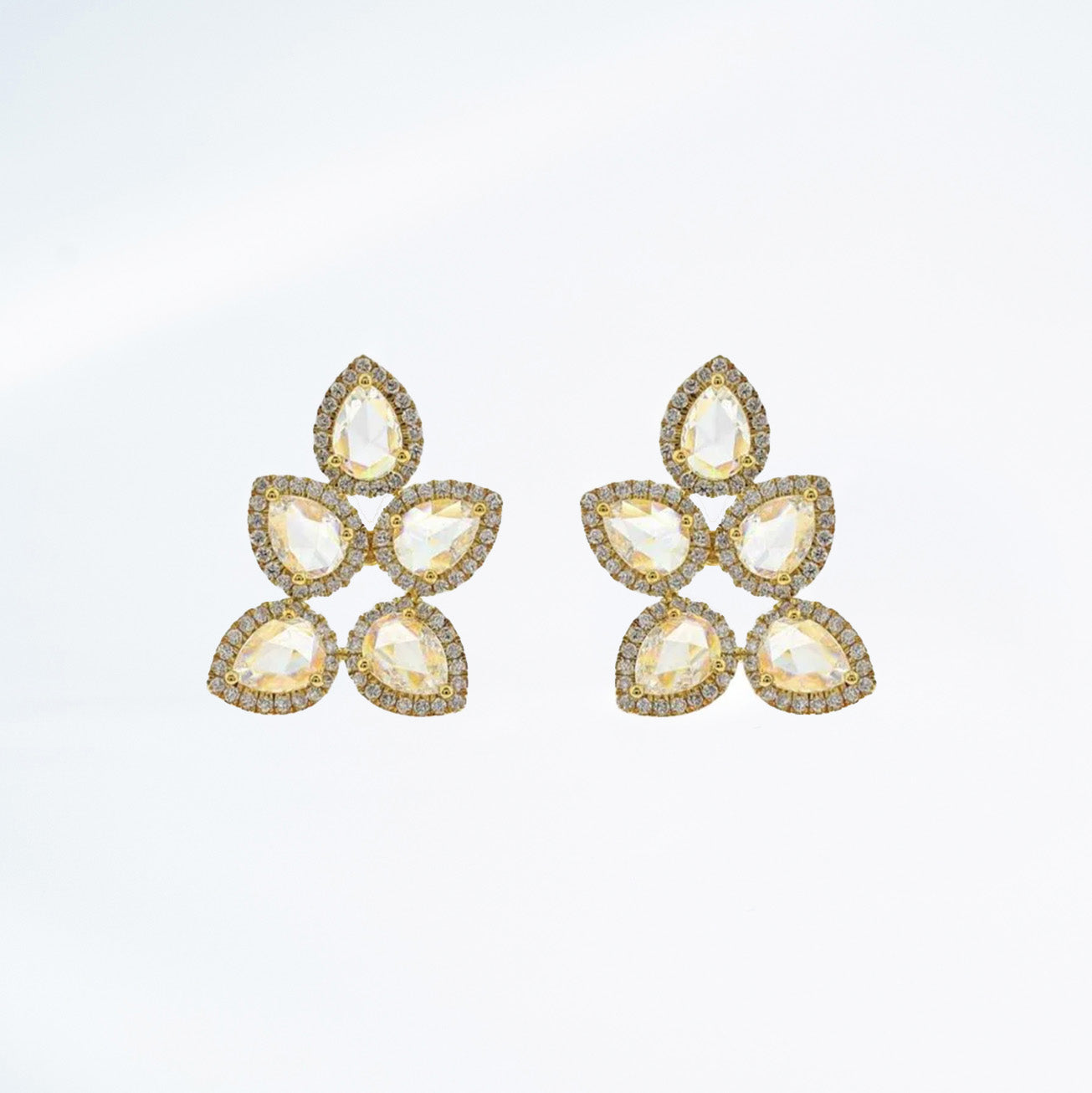 18k yellow gold and rose cut diamond earrings in the shape of a leaf. 5 points make up these earrings with pave diamond details.