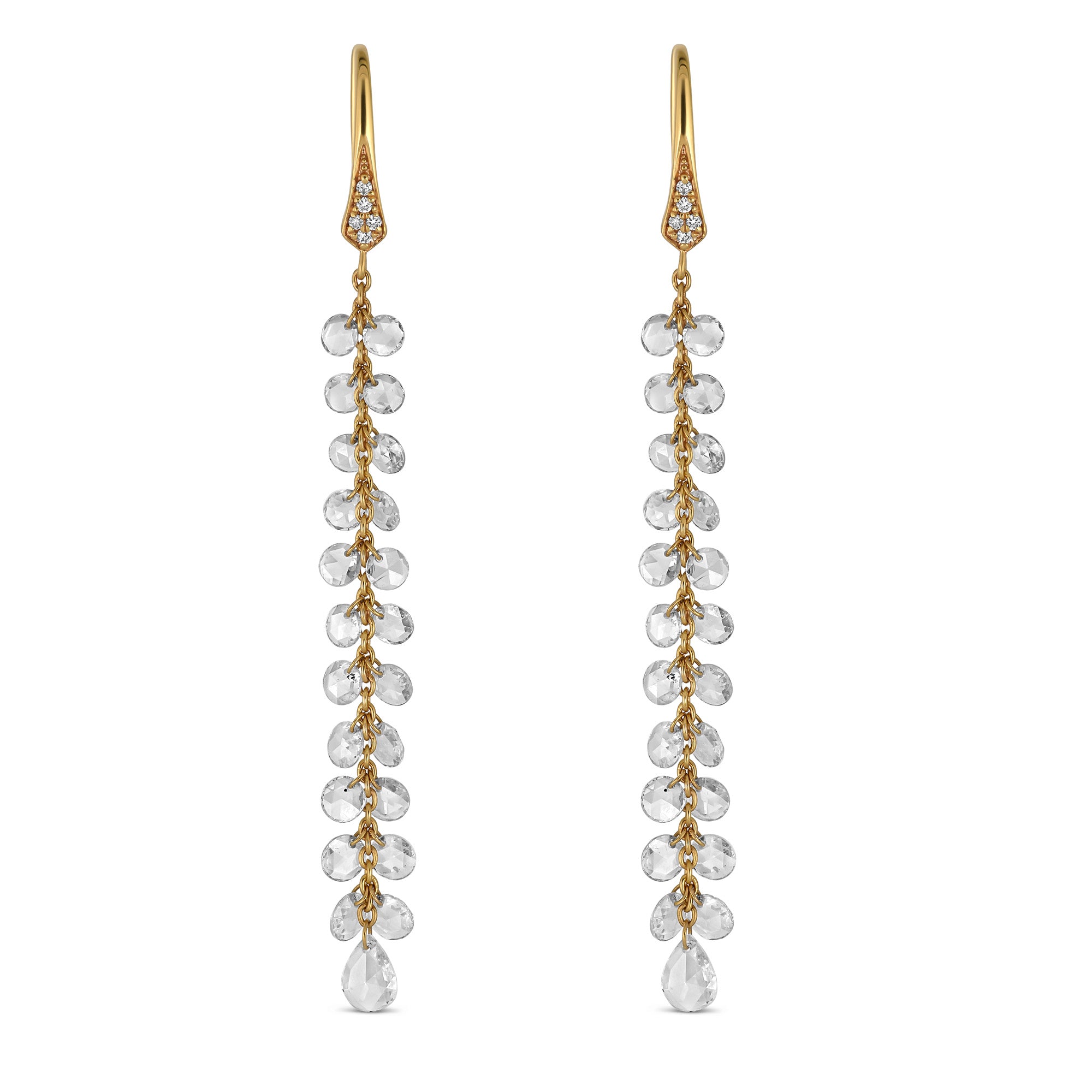 Gold earrings with rose cut diamonds on a light gray background
