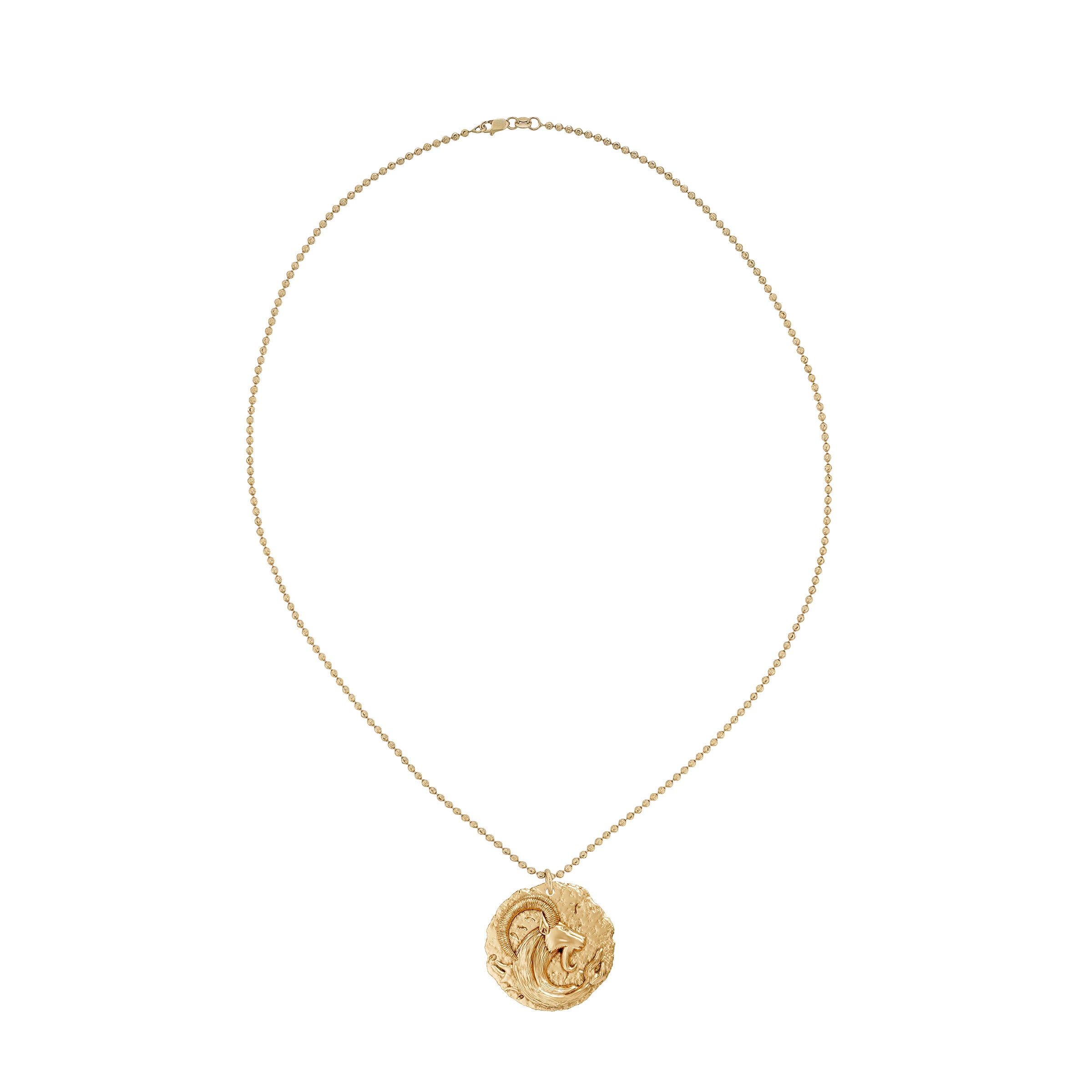 Gold necklace with a circular zodiac Capricorn pendant on a small ball chain on a white background
