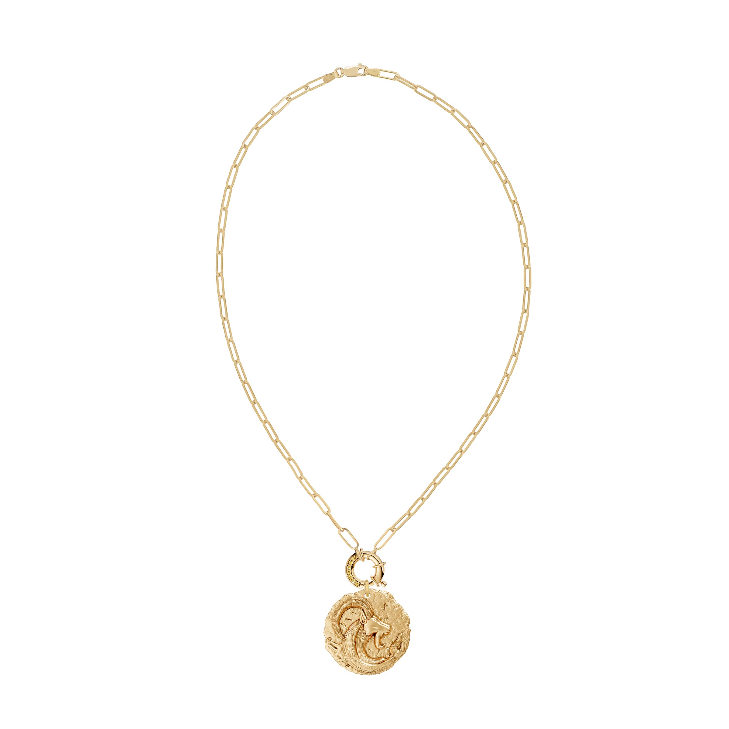 Gold necklace with a circular zodiac Capricorn pendant on a paperclip link chain and a yellow diamond clasp on a white background