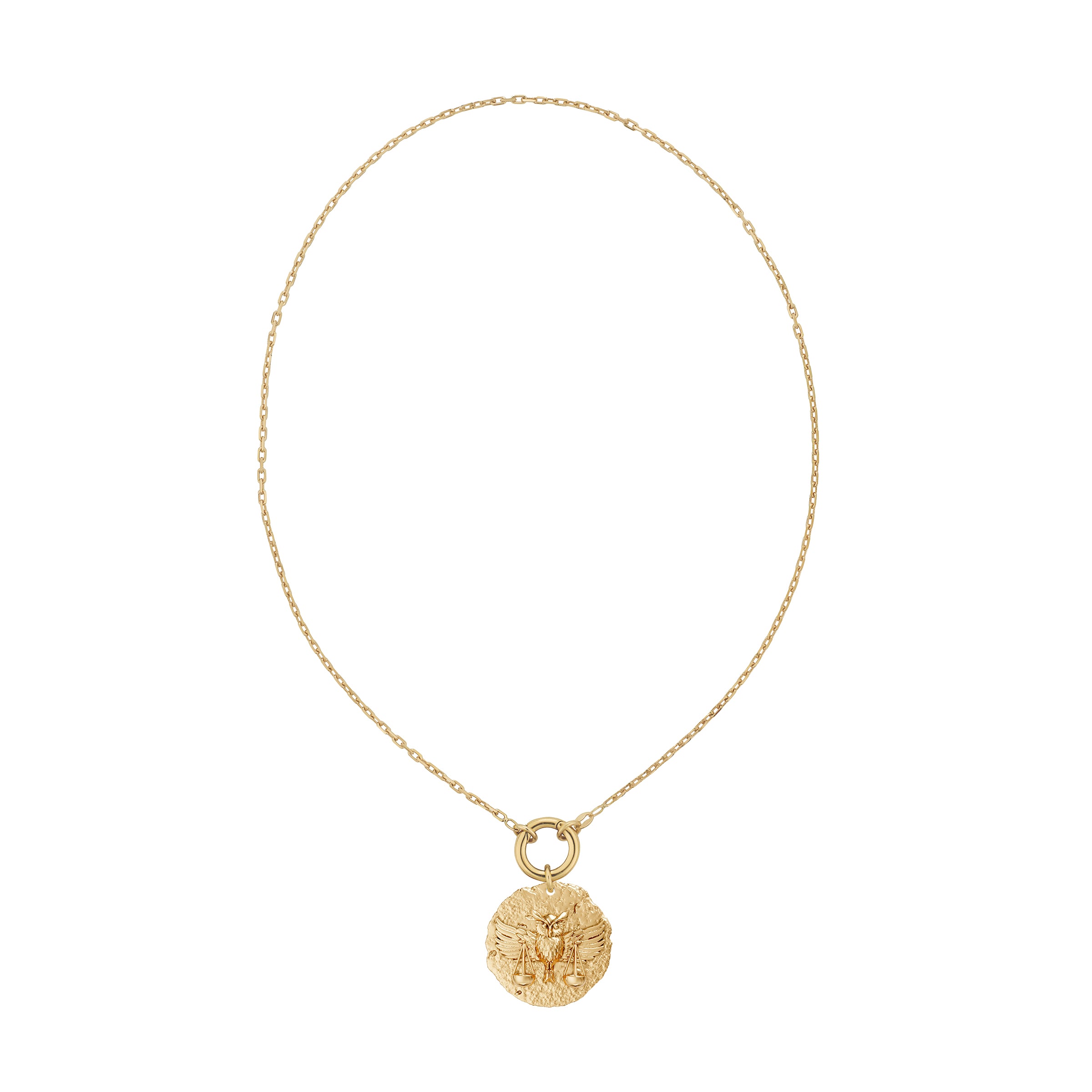 Gold necklace with a round zodiac libra pendant on link chain with decorative plain solid gold clasp on a white background