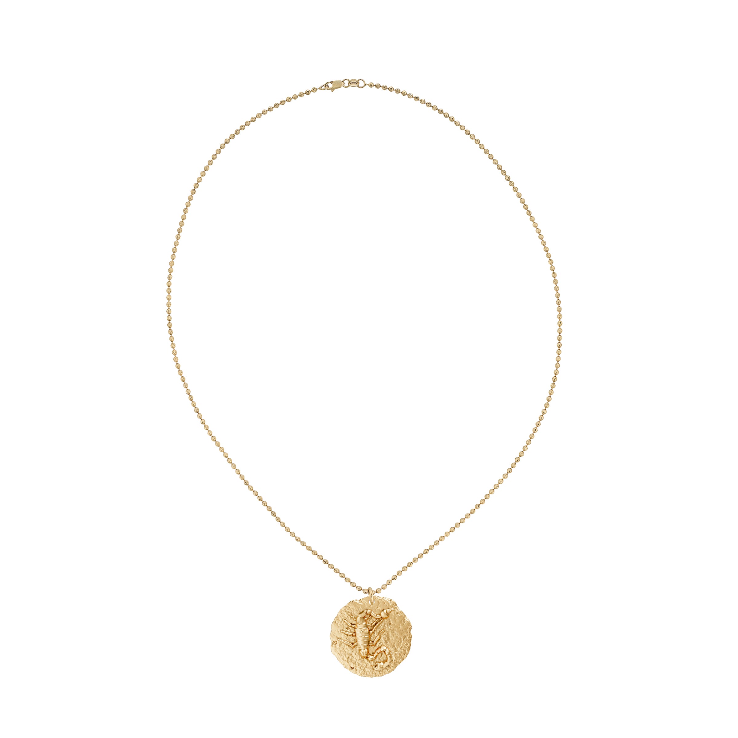 Gold necklace with a circular zodiac scorpio pendant on small ball chain on a white background