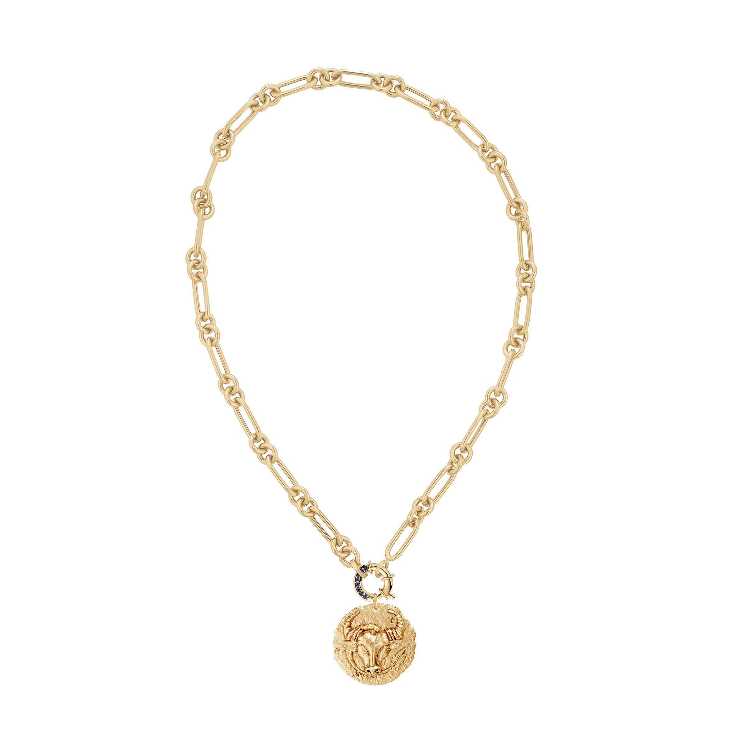 Gold necklace with a taurus zodiac pendant and a blue sapphire decorative clasp on a white background