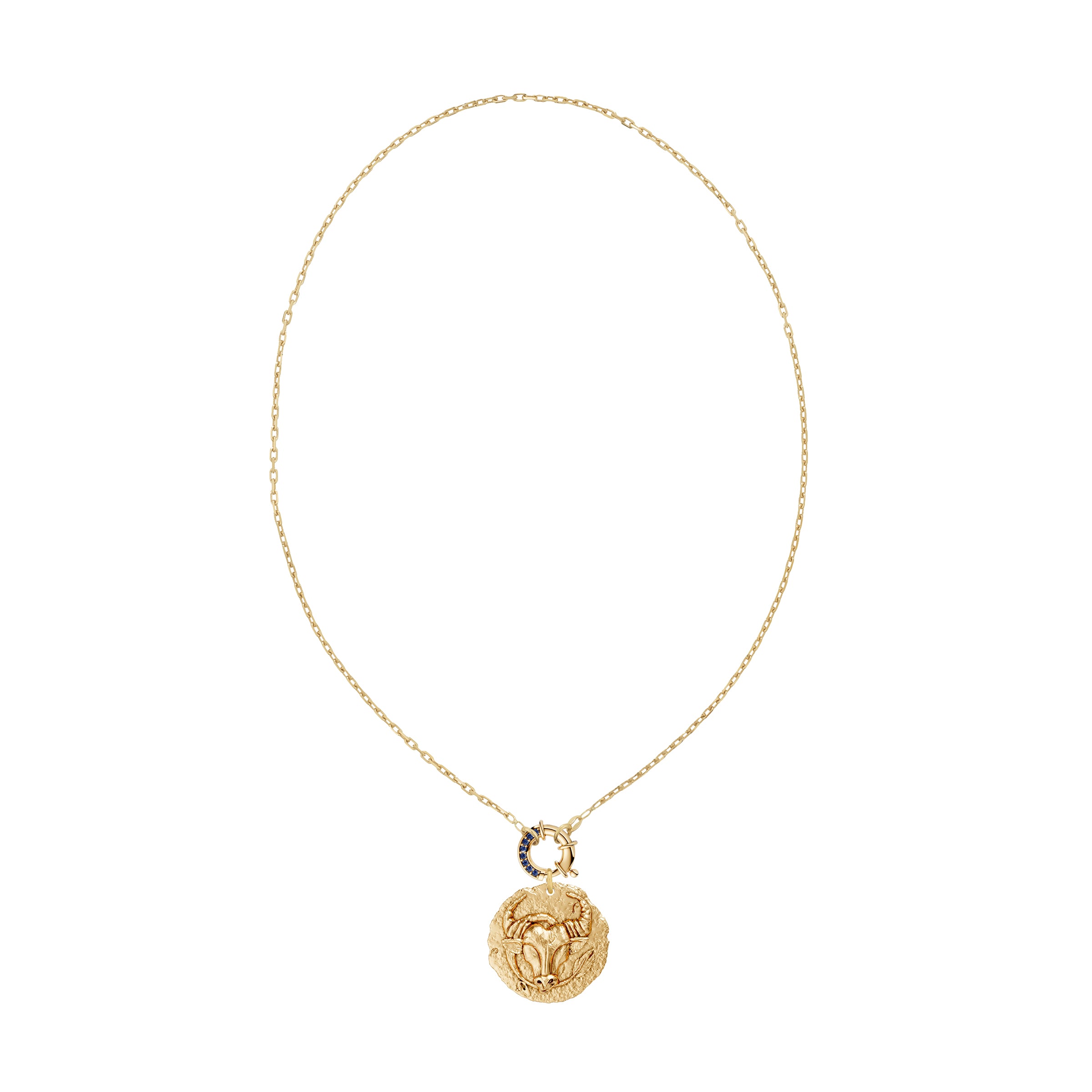 Gold necklace with a taurus zodiac pendant and a blue sapphire decorative clasp on a white background