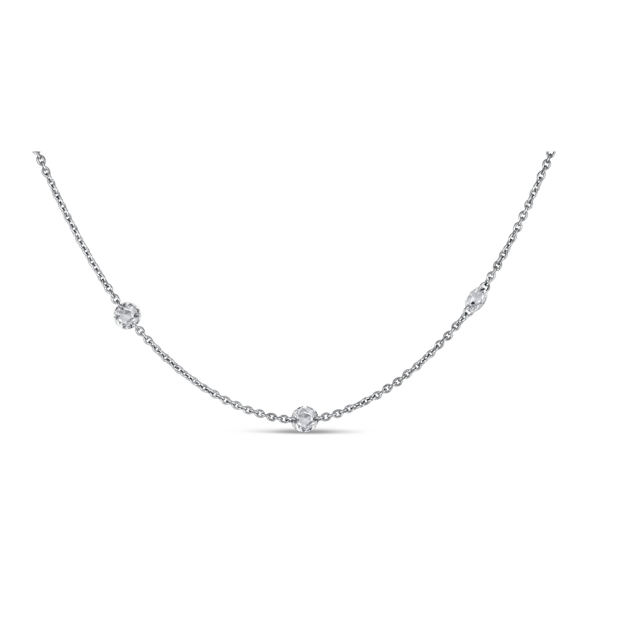 White gold chain necklace and rose cut diamonds on a white background