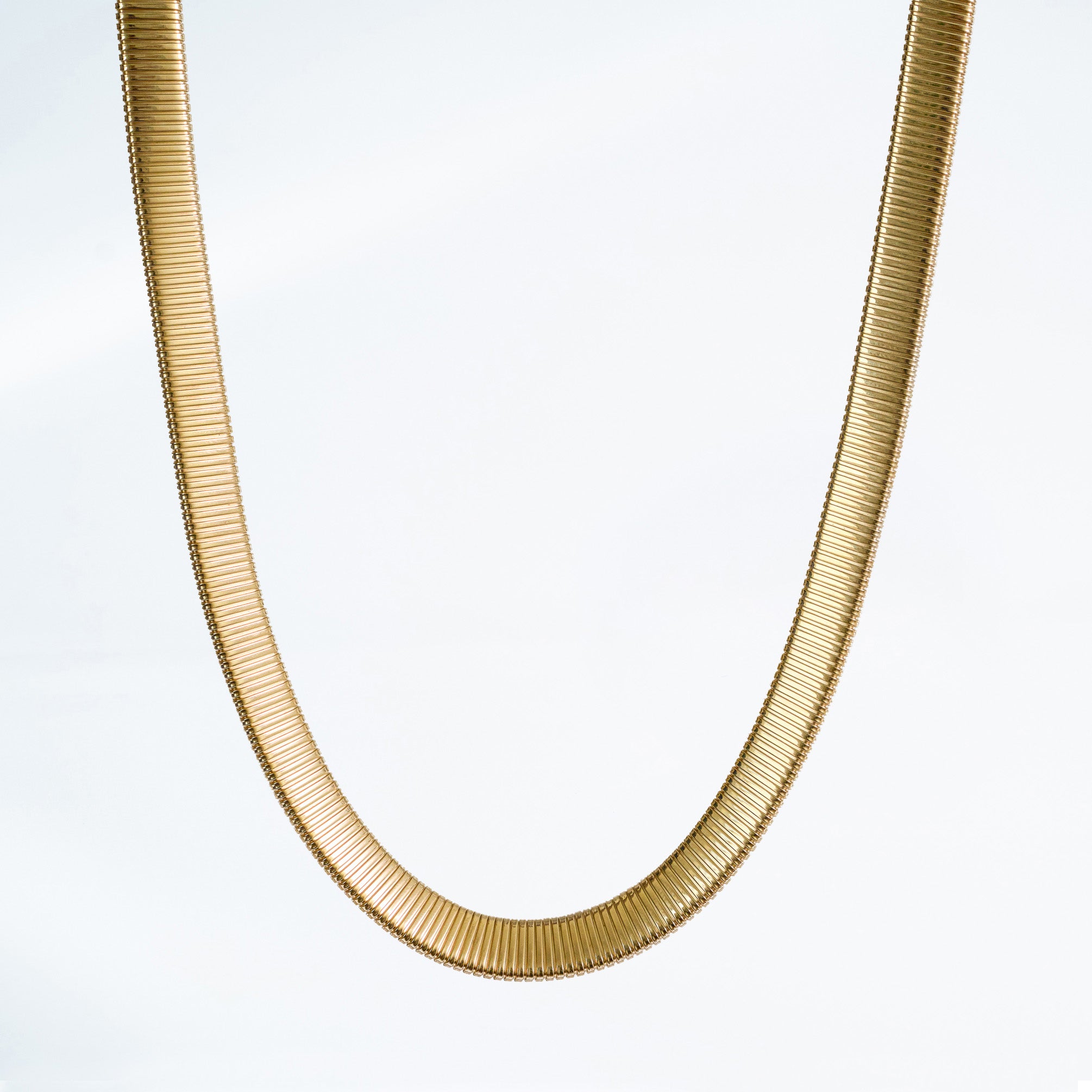 14k yellow gold tubogas necklace on a light gray background.