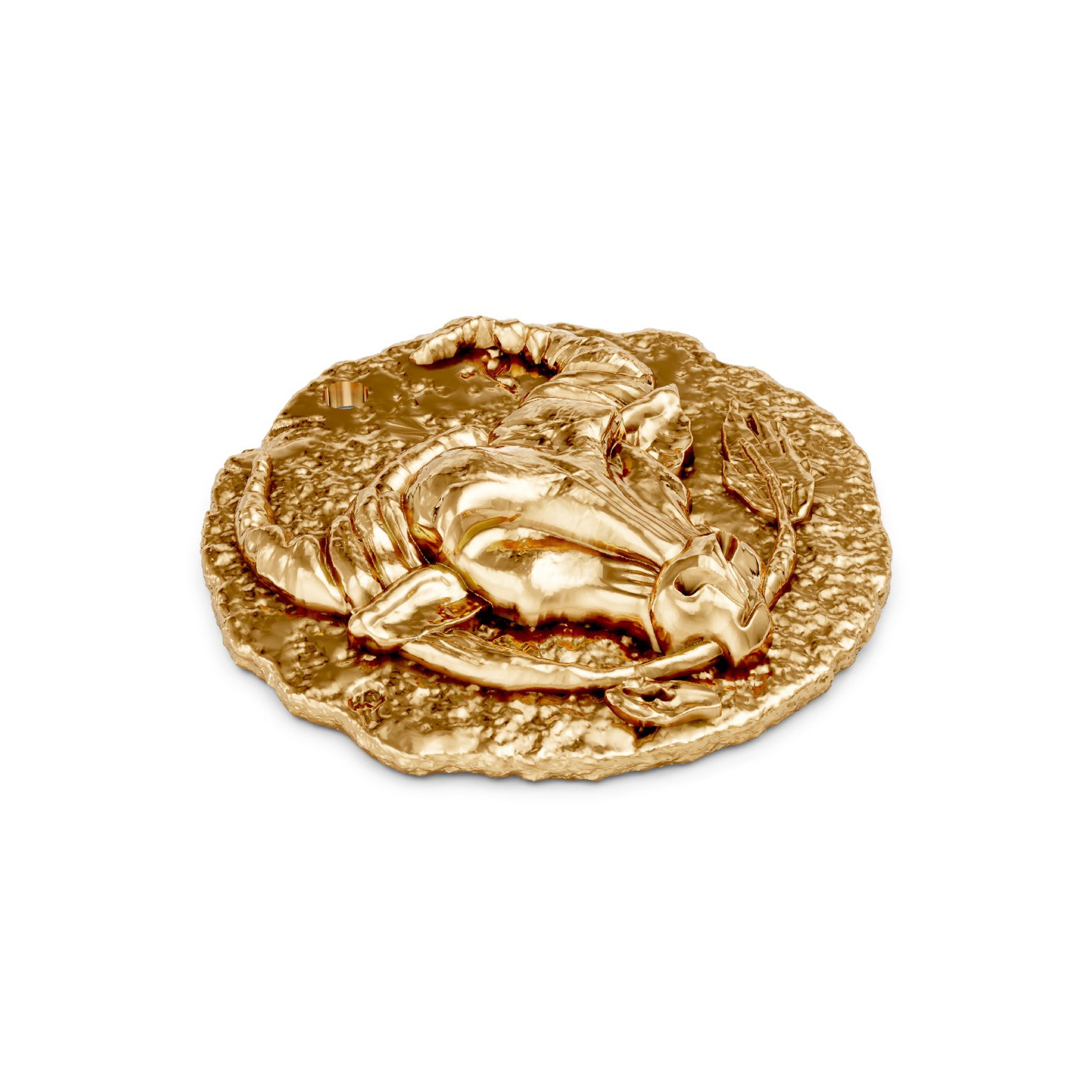Gold medallion with a bull taurus zodiac design on a white background