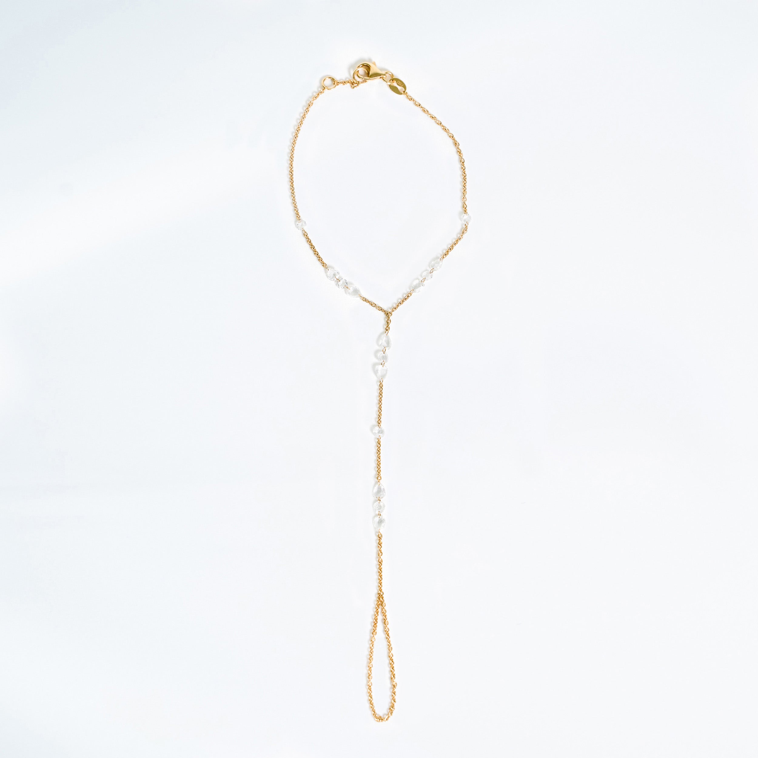 Rose cut diamonds on a 18k yellow gold hand chain. 
