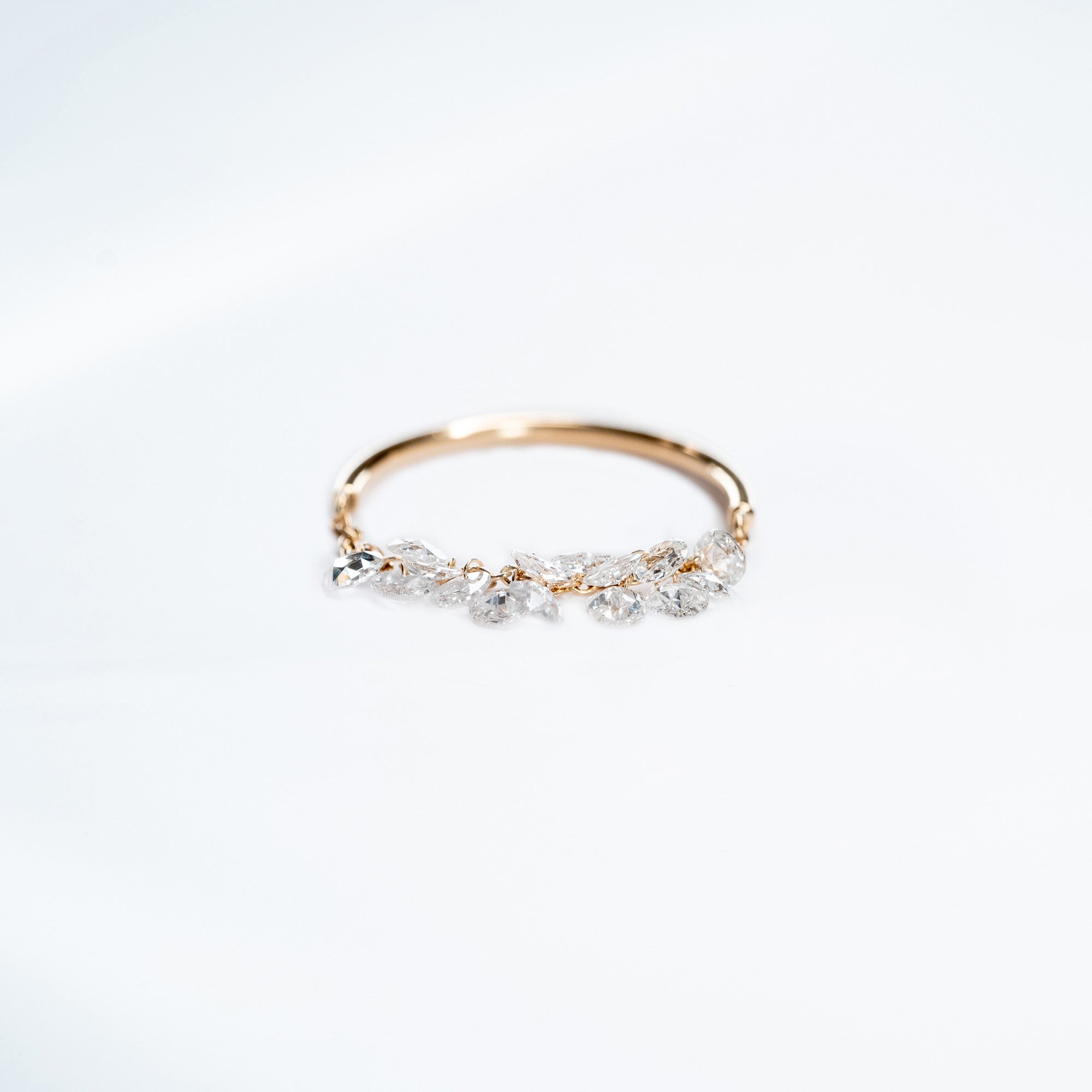 Gold ring with small diamonds on a white background. Rose cut dimaonds on 18k gold chain. 