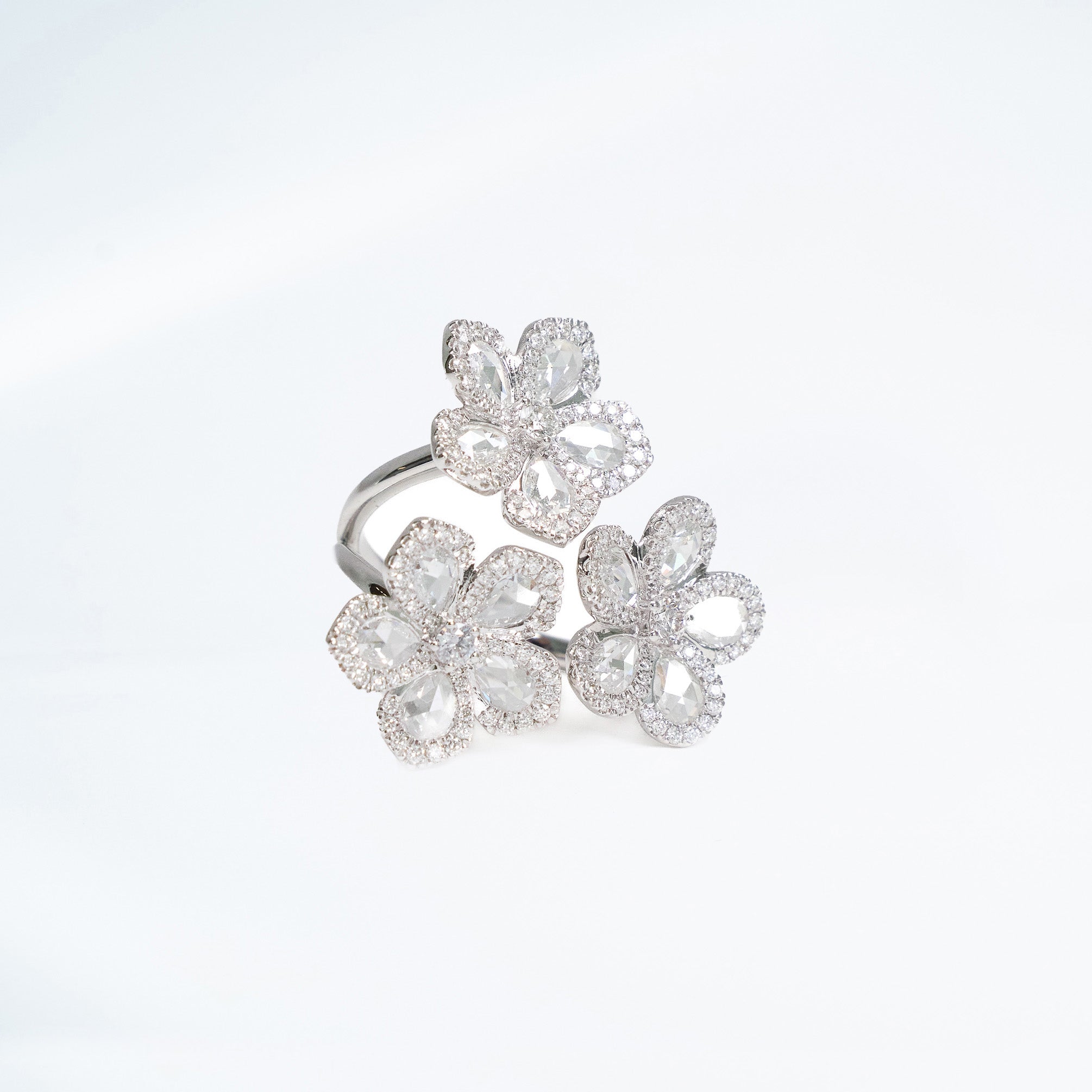 3 flower ring made out of rose cut natrual mined diamonds and pave diamonds to add extra sparkle set in 18k white gold