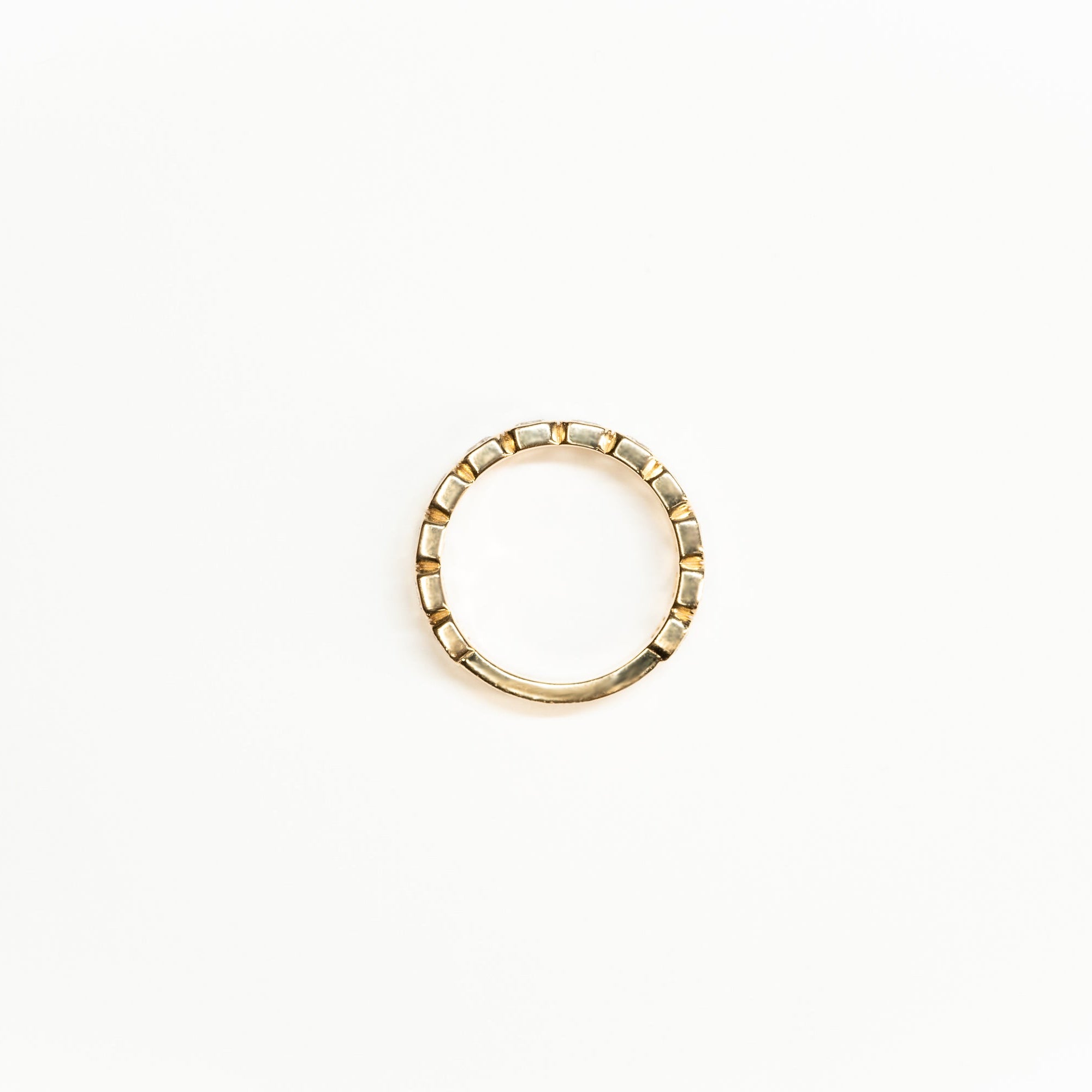 Side angle of emerald Cut Lab Diamond eternity band ste in 14k yelllow gold. 