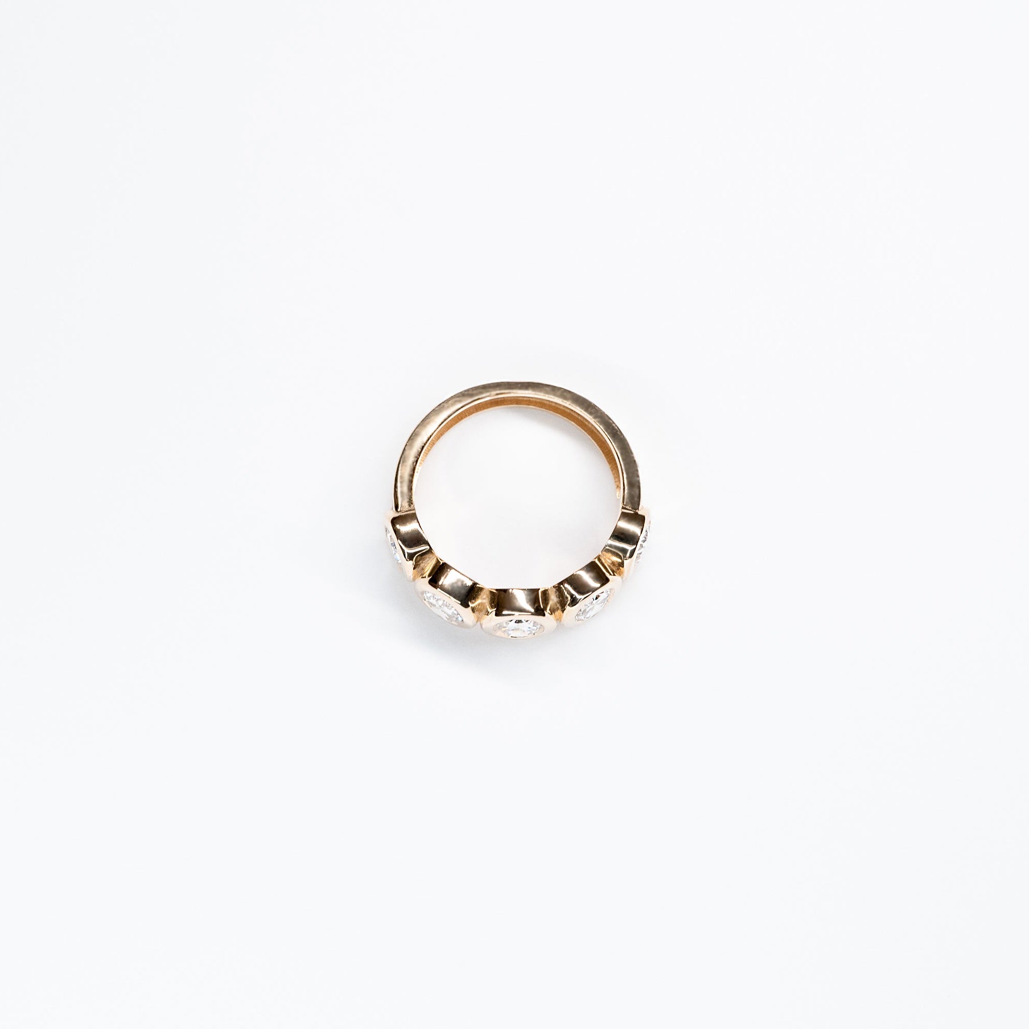 Side angle of Five Oval Lab Diamond Ring set in 14k Yellow Gold. All oval diamonds are the same carat weight.