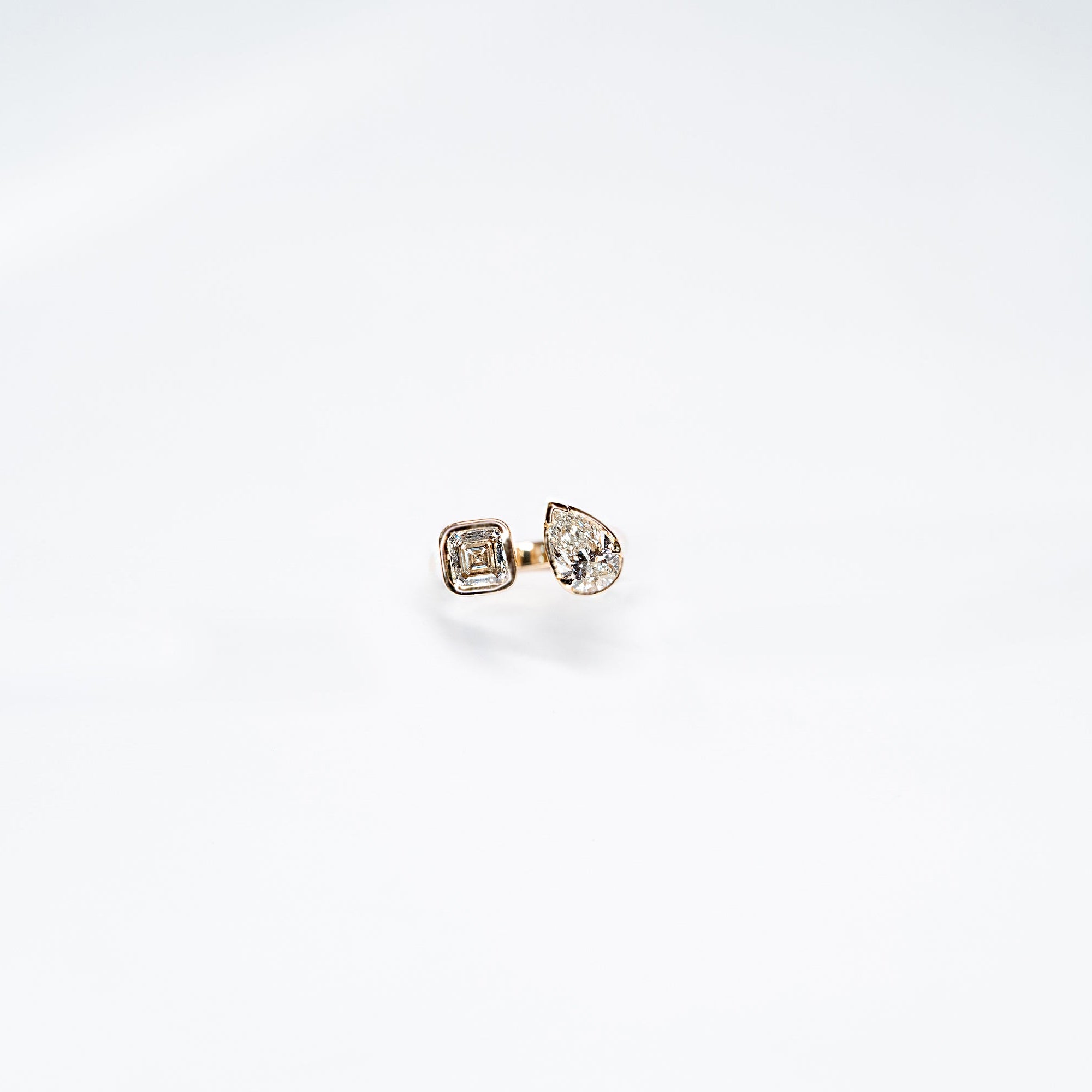 Toi Moi Lab Diamond ring set in 14k white gold.  One radiant diamond and One Pear Diamond. 