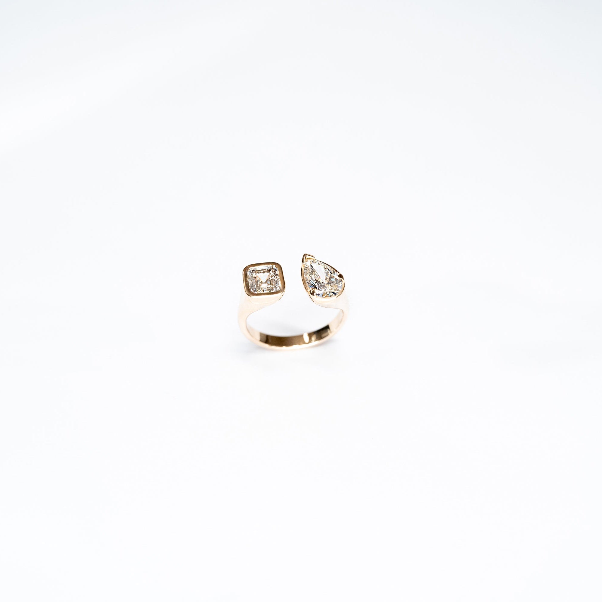 Toi Moi Lab Diamond ring set in 14k white gold.  One radiant diamond and One Pear Diamond. 