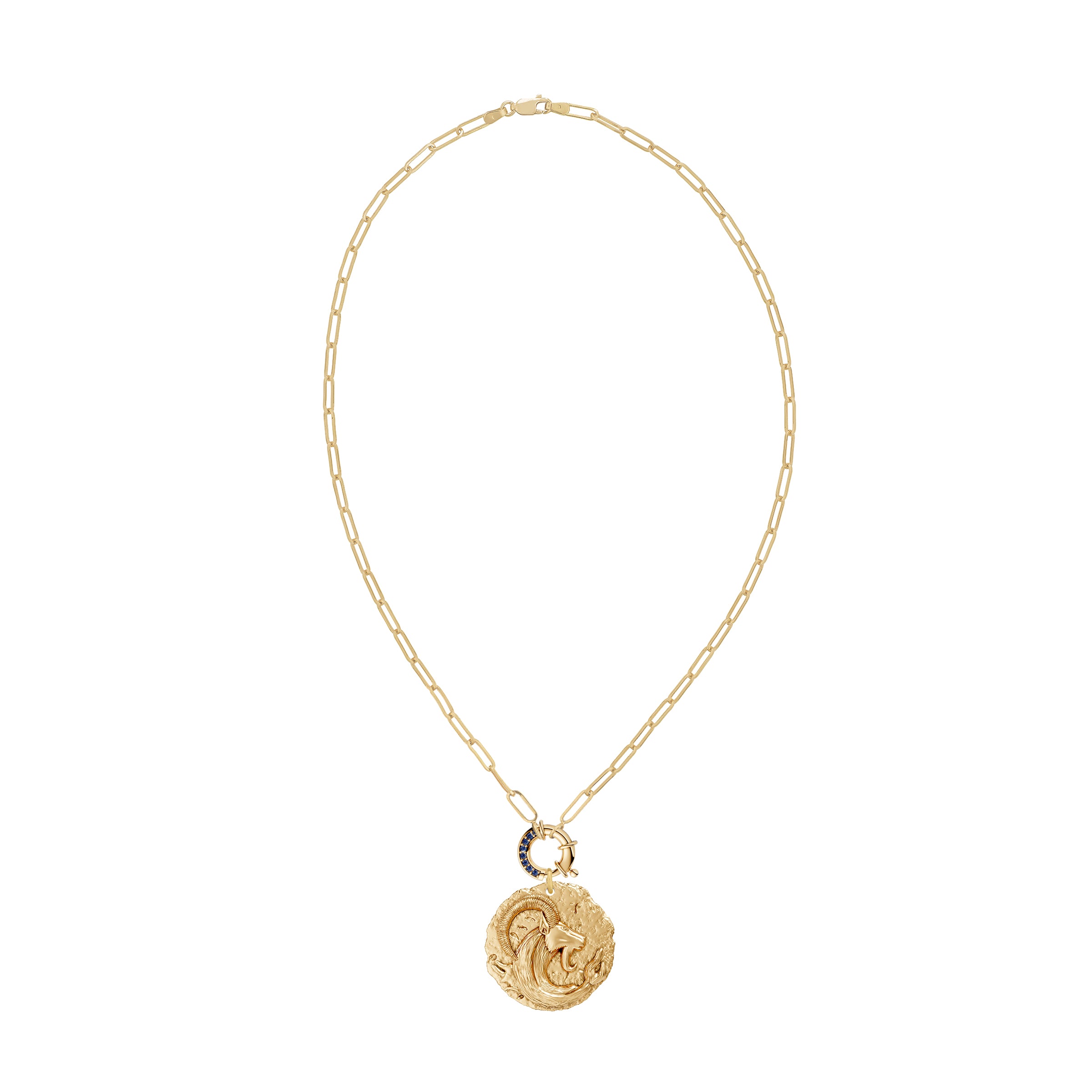 Gold necklace with a circular zodiac Capricorn pendant on a paperclip link chain and a blue sapphire clasp on a white background