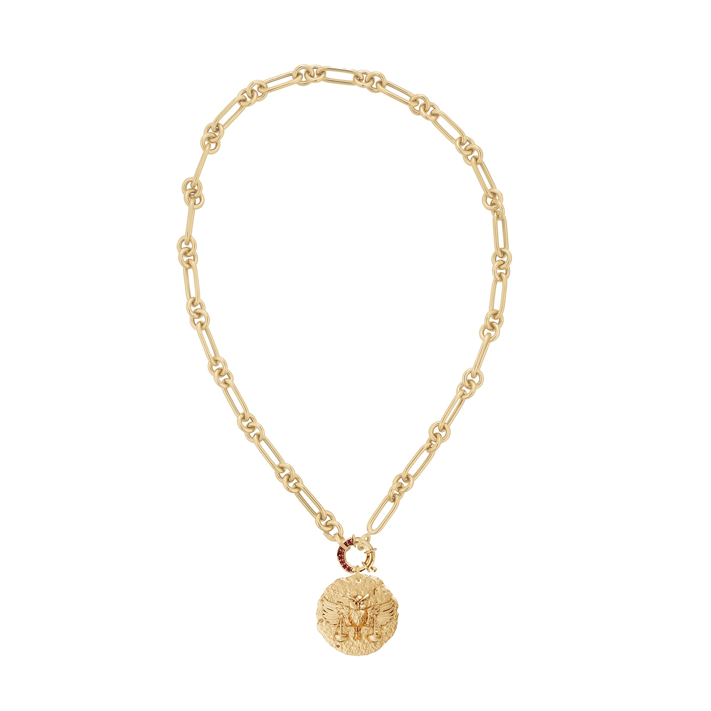 Gold necklace with a round zodiac libra pendant on link chain with decorative ruby clasp on a white background
