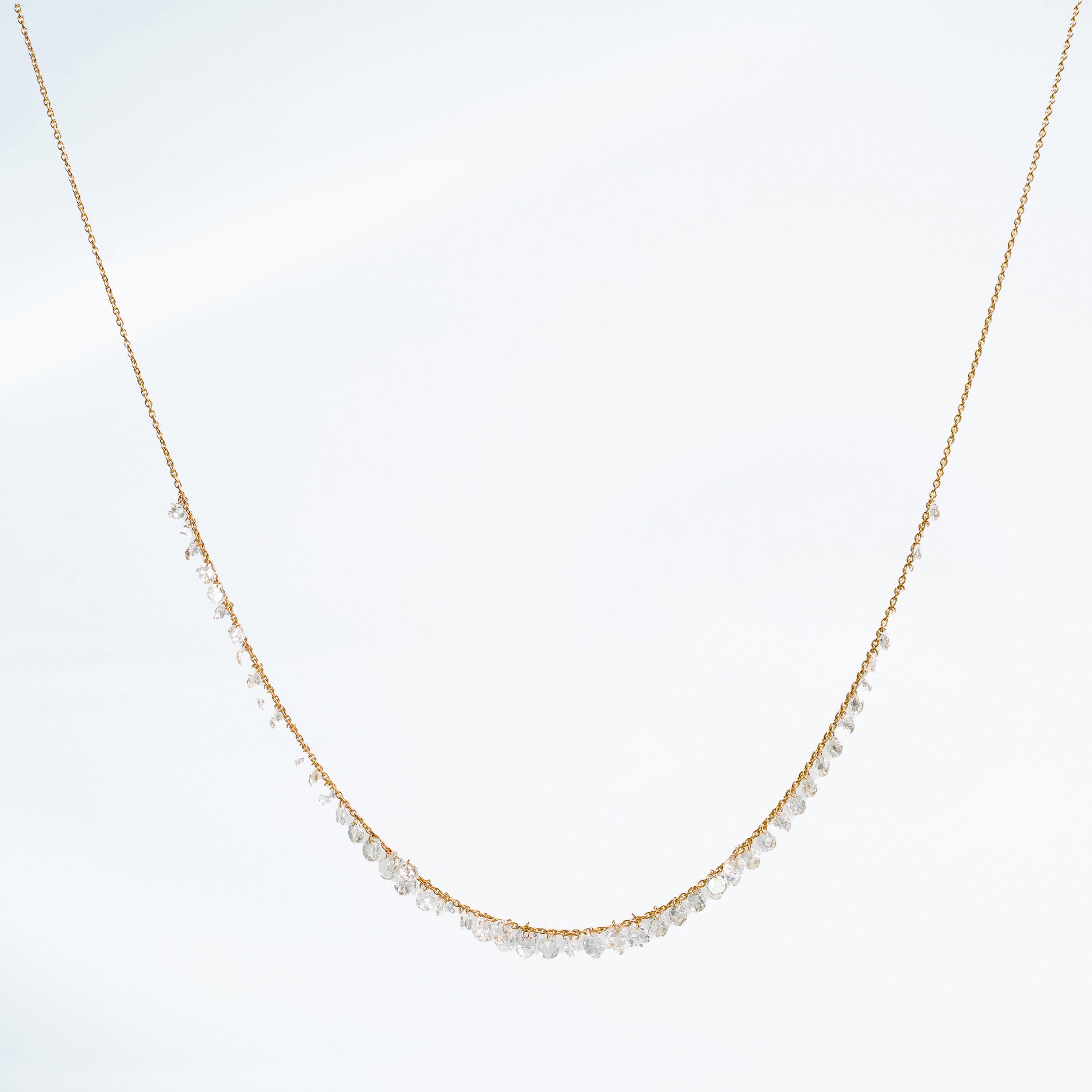 Rose cut diamond necklace set in yellow gold on white background