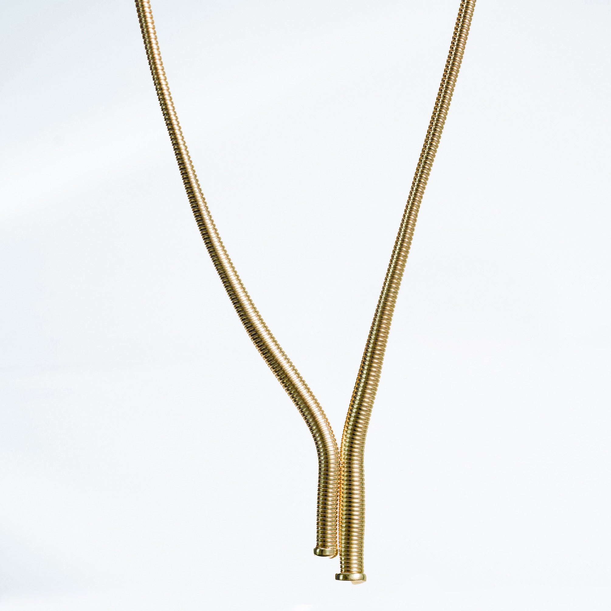 14k yellow gold tubogas necklace on a light gray background