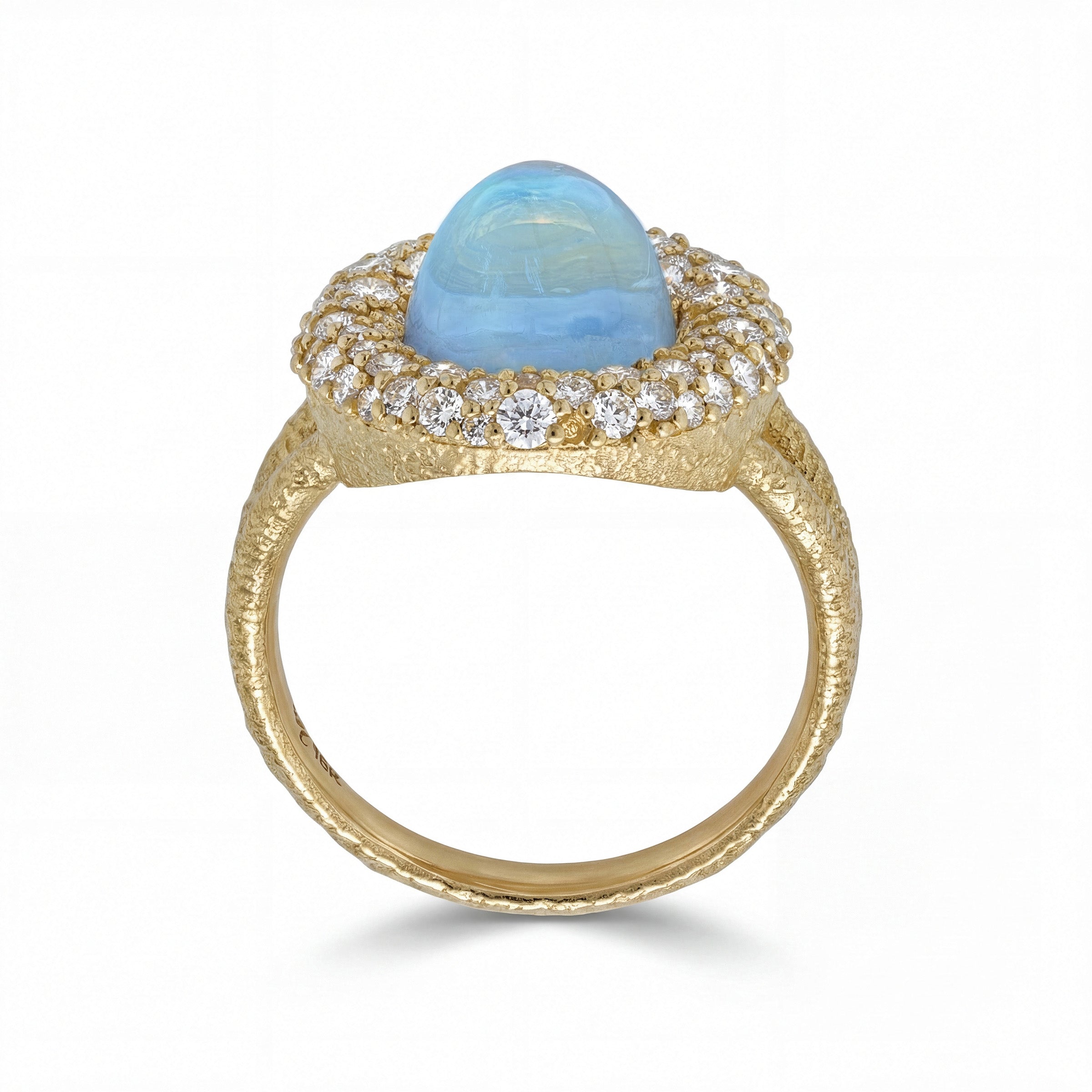 Gold ring with a blue sheen, moonstone and pave diamond accents on a white background
