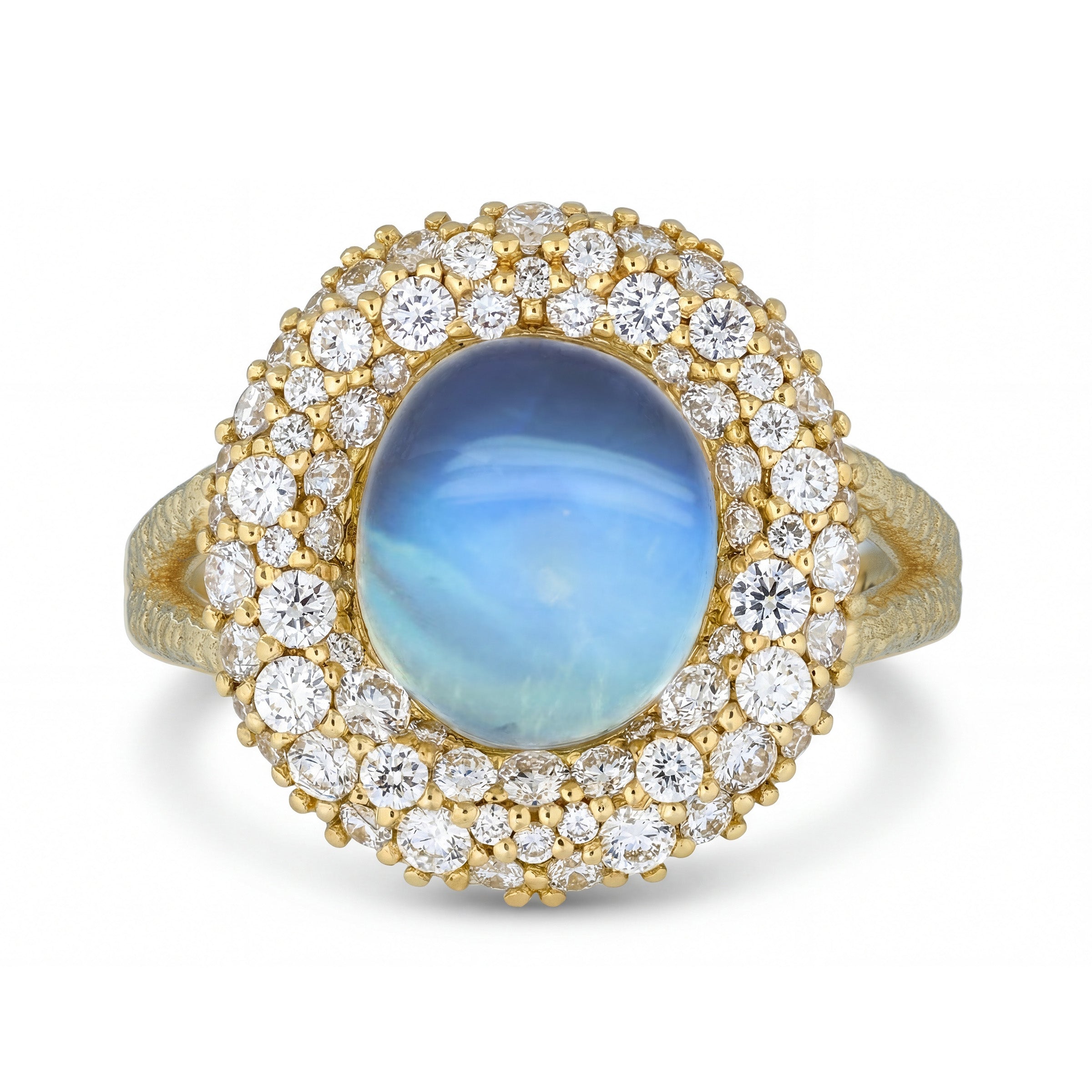 Gold ring with a blue sheen, moonstone and pave diamond accents on a white background