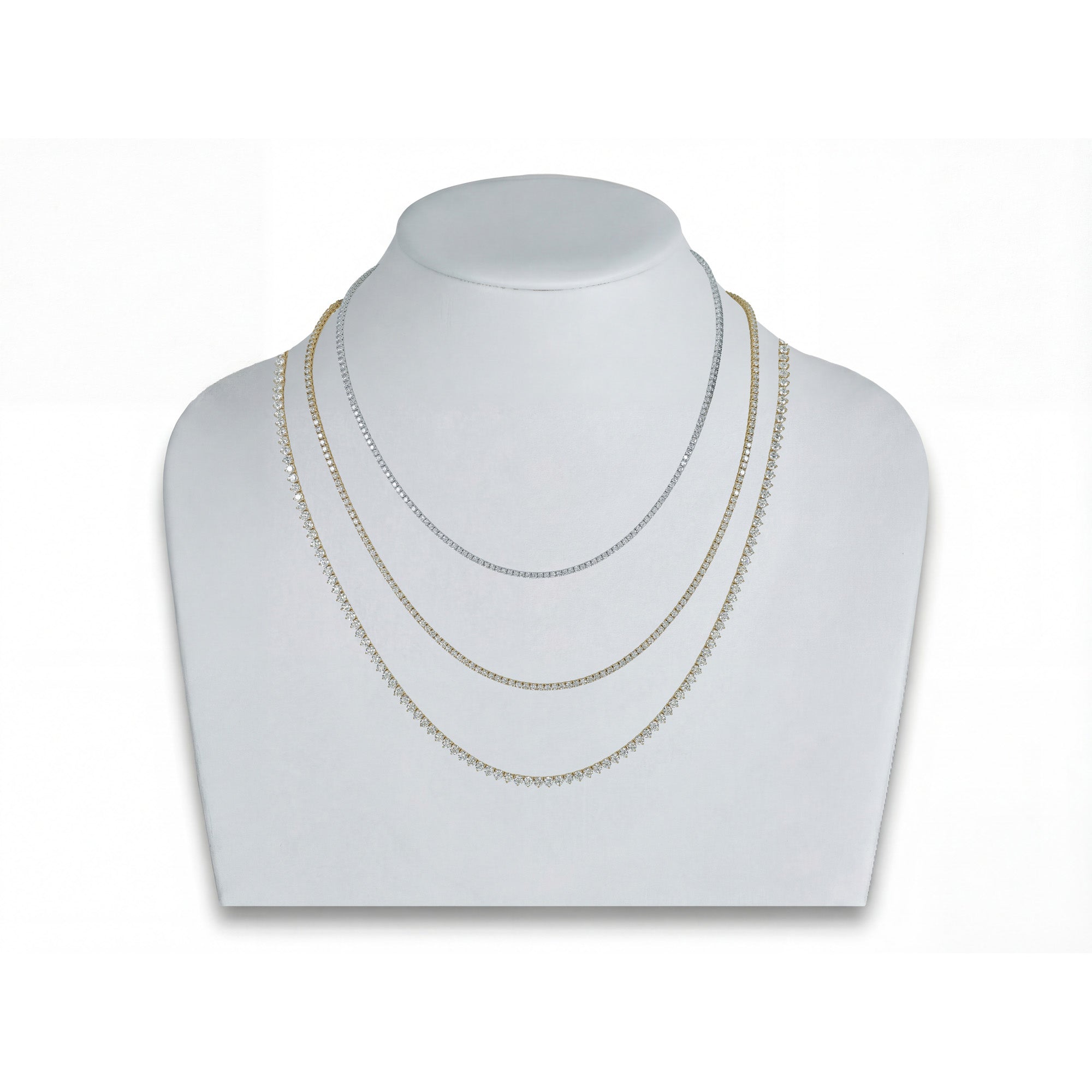 Three necklaces on a white mannequin bust against a white background