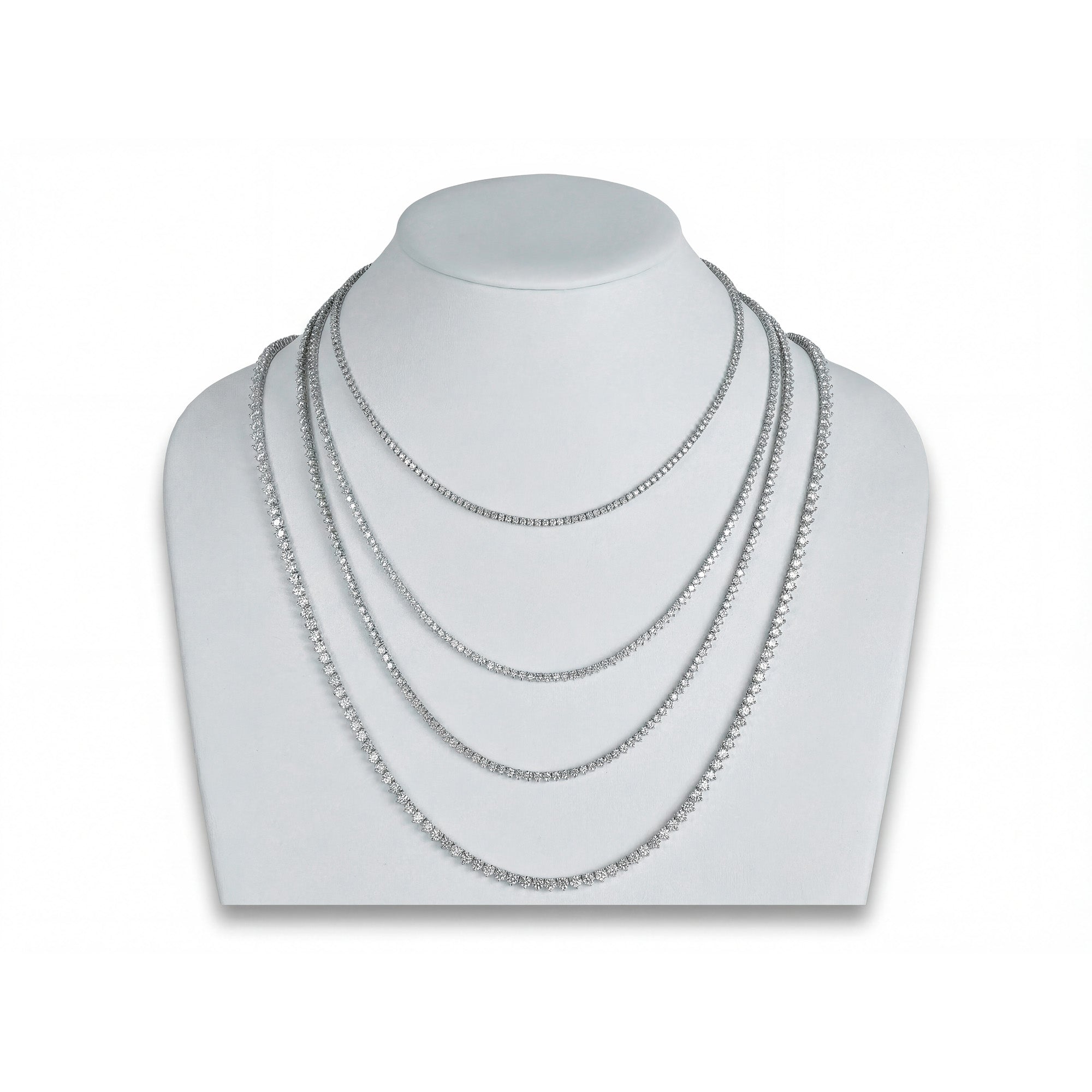 Set of silver necklaces on a mannequin bust against a white background