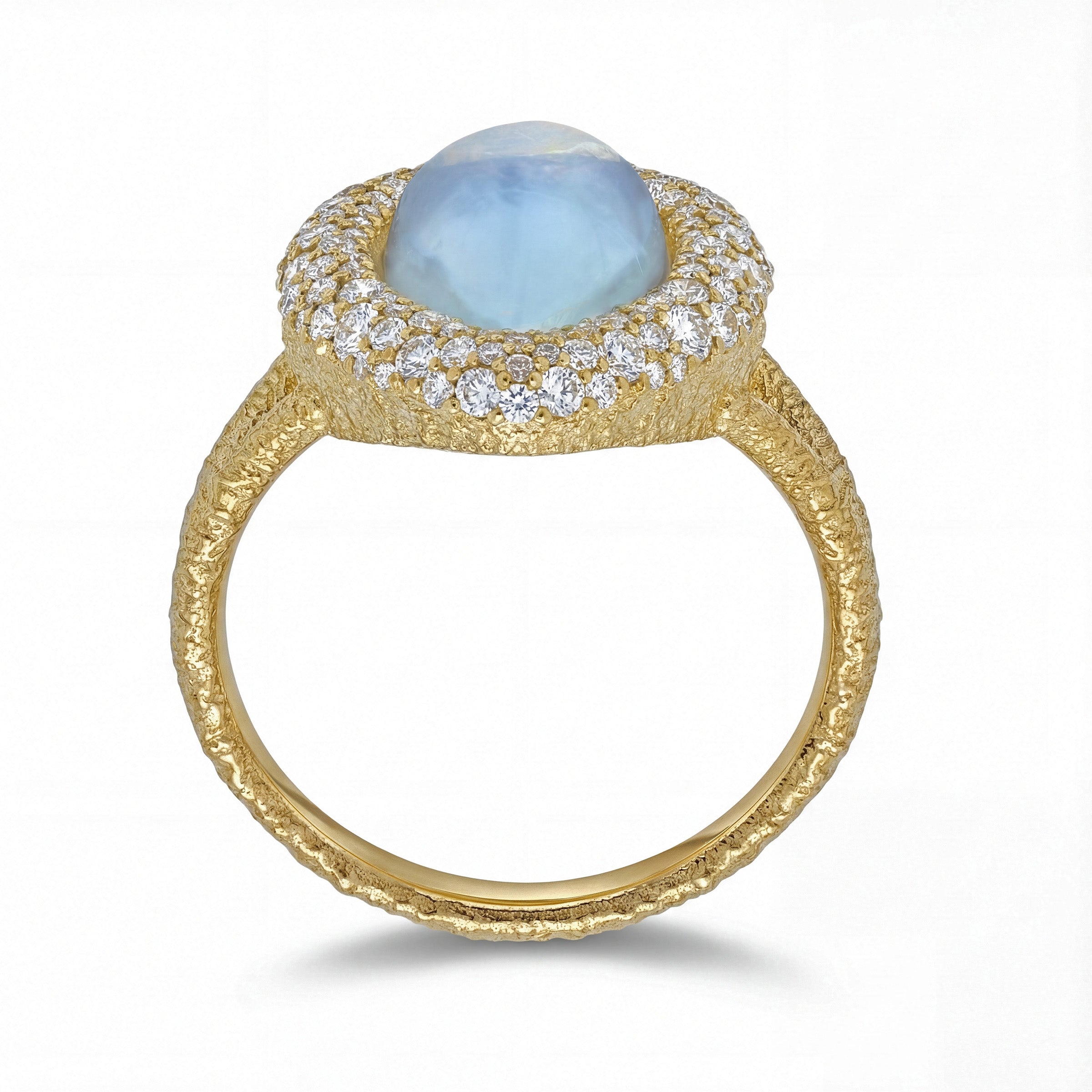 Gold ring with a teardrop-shaped blue sheen moonstone and diamond pave accents on a white background