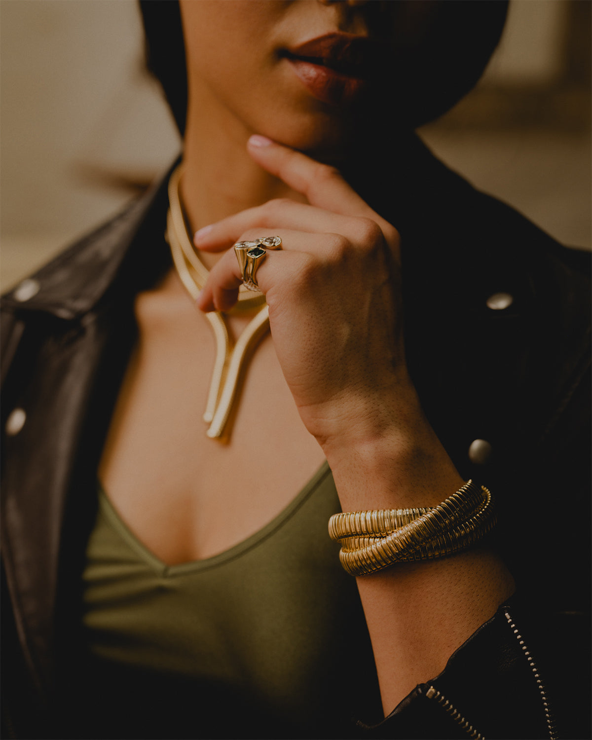 18K Yellow Gold three strand tubogas bracelet from the Eleuthera Zo.  Petite 10MM - Model wearing bracelet and rings from The Rumours Collection. 